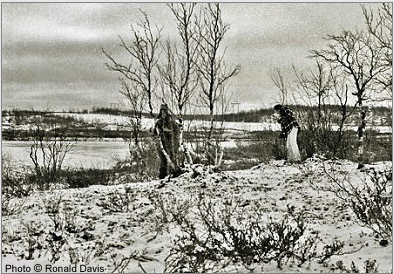 Myrdene Anderson (left) and Stanley Roseman (right) collecting brushwood and twigs with which to build a smokey fire at the river's edge to signal Ris'ten's brother to come to get them in his rowboat. Kautokeino, 1976. Photo  Ronald Davis